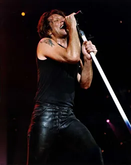 Jon Bon Jovi Pop Singer for Bon Jovi group on stage singing into microphone Jon Bon Jovi Pop Singer for Bon Jovi group on stage singing into microphone