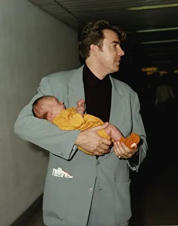 Jonathan Ross TV presenter holds baby in arms Jonathan Ross TV presenter holds baby in arms