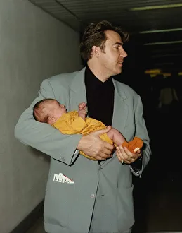 Jonathan Ross TV presenter holds baby in arms Jonathan Ross TV presenter holds baby in arms