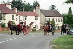Judges in horse-drawn carriages view the village of Hartlebury, Worcestershire Judges in horse-drawn carriages view the village of Hartlebury, Worcestershire