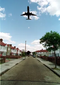 Jumbo Jet flying over the suburban streets June 1998 near Heathrow Airport Jumbo Jet flying over the suburban streets June 1998 near Heathrow Airport