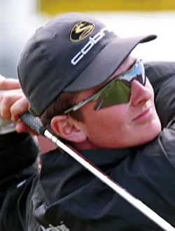 Justin Rose hits a drive down the fairway of the second which is reflected in his Justin Rose hits a drive down the fairway of the second which is reflected in his