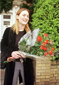 Kate Winslet holding bouquet of flowers outside her home as she told of her love for film Kate Winslet holding bouquet of flowers outside her home as she told of her love for film