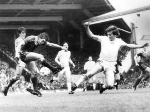 Ken McNaught blocks a shot from fellow scot Kenny Dalglish during the Liverpool v Ken McNaught blocks a shot from fellow scot Kenny Dalglish during the Liverpool v