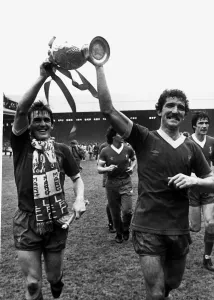 Kenny Dalglish with Graeme Souness proudly holding aloft League Championship trophy at Kenny Dalglish with Graeme Souness proudly holding aloft League Championship trophy at