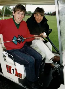 Kenny Dalglish and Stephen Hendry at golf course in golf cart holding club Kenny Dalglish and Stephen Hendry at golf course in golf cart holding club