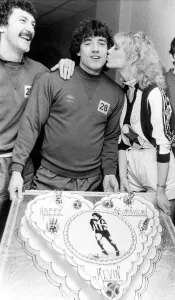 Kevin Keegan gets his birthday kiss from Julie Parkinson watched by team mate Terry Kevin Keegan gets his birthday kiss from Julie Parkinson watched by team mate Terry