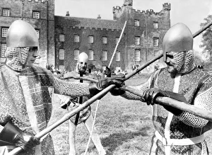 Knaves in jerkins and steel helmets battle with quarter staffs during the jousting at Knaves in jerkins and steel helmets battle with quarter staffs during the jousting at
