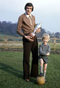 Leeds United footballer Norman Hunter with his five year old son Michael holding Leeds United footballer Norman Hunter with his five year old son Michael holding