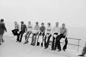 Leeds United players sit on a railing on the promenade as they take a walk around Leeds United players sit on a railing on the promenade as they take a walk around