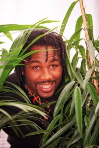 Lennox Lewis Boxer at a Press Conference - surrounded by plants Lennox Lewis Boxer at a Press Conference - surrounded by plants