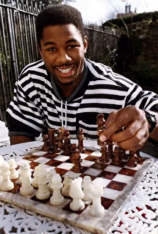 Lennox Lewis Boxing Heavyweight Boxer sitting at table playing chess Lennox Lewis Boxing Heavyweight Boxer sitting at table playing chess