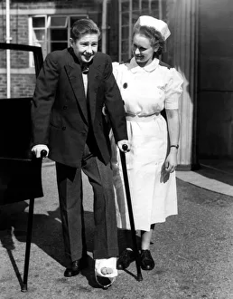 Lester Piggott with a nurse and broken foot or toe. 15th September 1951 Lester Piggott with a nurse and broken foot or toe. 15th September 1951