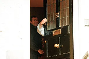Liam Gallagher puts his hand around the door and gestures to the press Liam Gallagher puts his hand around the door and gestures to the press
