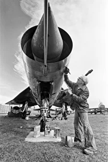 A Lightning aircraft being painted and restored by a workman at the Midland Air Museum at A Lightning aircraft being painted and restored by a workman at the Midland Air Museum at