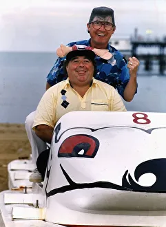 Little & Large Comedy Duo Sitting in toy car on beach wearing funny hat and wig Dbase Little & Large Comedy Duo Sitting in toy car on beach wearing funny hat and wig Dbase
