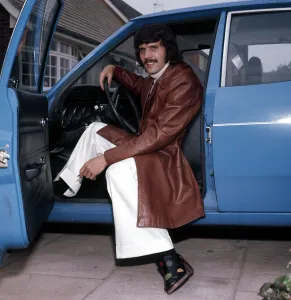 Liverpool footballer Peter Cormack in his car, wearing some of the clothes he has Liverpool footballer Peter Cormack in his car, wearing some of the clothes he has