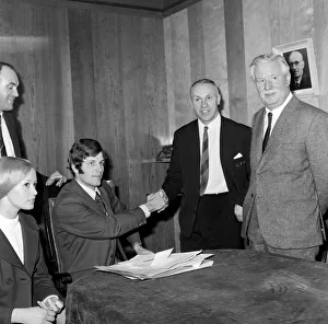 Liverpool's new signing John Toshack from Cardiff City signs his contract accompanied Liverpool's new signing John Toshack from Cardiff City signs his contract accompanied