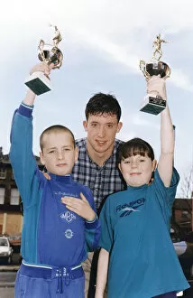 Images Dated 20th November 1994: Liverpools Robbie Fowler handing out prizes to youngsters Steven Beck (Prince