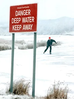 A lone figure skater ignores a prominent sign to skate on a frozen lake in West Boldon in A lone figure skater ignores a prominent sign to skate on a frozen lake in West Boldon in