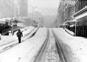 A lone pedestrian walks down Corporation Street near Lewis's Store. Birmingham A lone pedestrian walks down Corporation Street near Lewis's Store. Birmingham