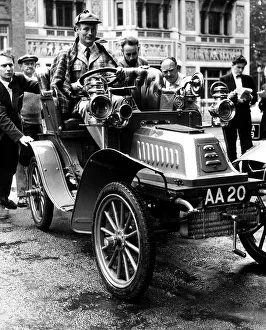 Lord Montagu of Beaulieu July 1958 at the wheel of his car as it is manhandled into Lord Montagu of Beaulieu July 1958 at the wheel of his car as it is manhandled into