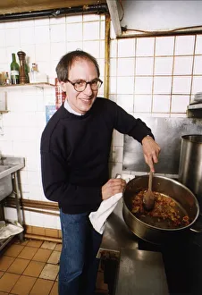 Loyd Grossman TV Presenter of Master Chef in his own kitchen trying out his own cooking Loyd Grossman TV Presenter of Master Chef in his own kitchen trying out his own cooking