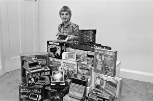 A lucky child surrounded by a selection of electronic games available in the shops this A lucky child surrounded by a selection of electronic games available in the shops this