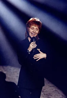 Lulu singer & actress singing at a Royal Command Performance on stage with microphone Lulu singer & actress singing at a Royal Command Performance on stage with microphone