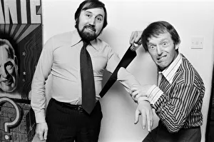 Magician Paul Daniels shows off a trick as he cuts Ken Irwin's arm off Magician Paul Daniels shows off a trick as he cuts Ken Irwin's arm off