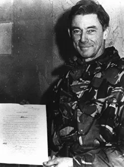 Major General Jeremy Moore holds the surrender document signed by General Mario Menendez Major General Jeremy Moore holds the surrender document signed by General Mario Menendez