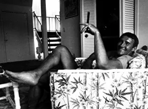 Images Dated 22nd April 1976: Malcolm Allison football manager 1976 sitting in armchair smoking large cigar