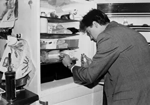 A man applies a swab test as he checks his fridge for bugs march 1991 A man applies a swab test as he checks his fridge for bugs march 1991