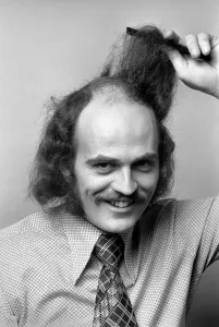 Man combing his hair. July 1975 75-00177-004 Man combing his hair. July 1975 75-00177-004