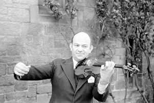 Man repairs strings on violin. January 1939 OL304G Man repairs strings on violin. January 1939 OL304G