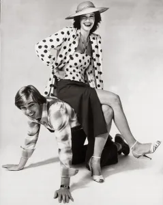 Man and woman in relaxed pose, the woman sitting on the man's back Man and woman in relaxed pose, the woman sitting on the man's back