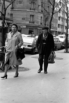 Man and woman walking down the street in Paris, France. April 1975 75-2079-009 Man and woman walking down the street in Paris, France. April 1975 75-2079-009