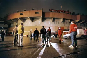 Manchester United fans bow their heads in respect during a slient vigil outside Old Manchester United fans bow their heads in respect during a slient vigil outside Old