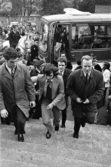 Manchester United football star George Best, surrounded by body guards after receiving Manchester United football star George Best, surrounded by body guards after receiving