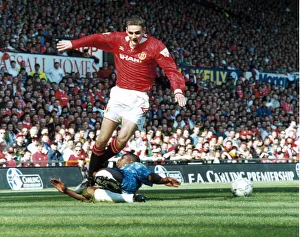 Manchester United footballer Colin McKee skips past the sliding challenge of a defender Manchester United footballer Colin McKee skips past the sliding challenge of a defender