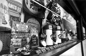 Manchester United merchandise including books, flags and scarves on sale at a store Manchester United merchandise including books, flags and scarves on sale at a store