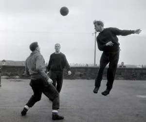 Manchester United player Bobby Charlton jumps up for a header watched by teammates Manchester United player Bobby Charlton jumps up for a header watched by teammates