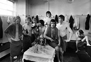 Manchester United players celebrate in the changing rooms after being promoted back into Manchester United players celebrate in the changing rooms after being promoted back into