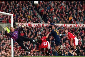 Manchester Uniteds goalkeeper Peter Schmeichel dives to save Wimbledons Dean Blackwell Manchester Uniteds goalkeeper Peter Schmeichel dives to save Wimbledons Dean Blackwell