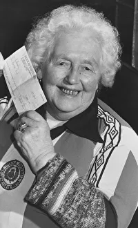 Margaret Cameron, 85, holds up her cheque for !000 after winning the first draw in Margaret Cameron, 85, holds up her cheque for !000 after winning the first draw in