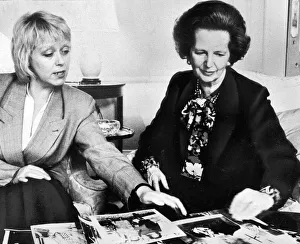 Margaret Thatcher looking over photographs with official - May 1987 Margaret Thatcher looking over photographs with official - May 1987