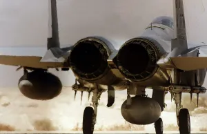 A McDonnell Douglas F15 Eagle of the USAF stands on the end of the runway ready to depart A McDonnell Douglas F15 Eagle of the USAF stands on the end of the runway ready to depart