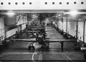 Mechanics working on the British Royal Navy aircraft carrier HMS Argus inside the hangar Mechanics working on the British Royal Navy aircraft carrier HMS Argus inside the hangar