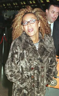 Mel B of the Spice Girls showing the two rings in her tongue as she went through Heathrow Mel B of the Spice Girls showing the two rings in her tongue as she went through Heathrow