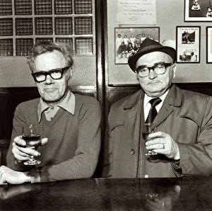 Two men enjoying a drink in their local pub April 1975 Two men enjoying a drink in their local pub April 1975